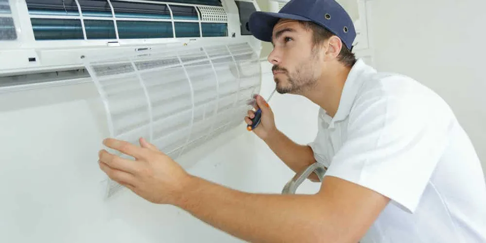 Technician checking an indoor heating and cooling unit